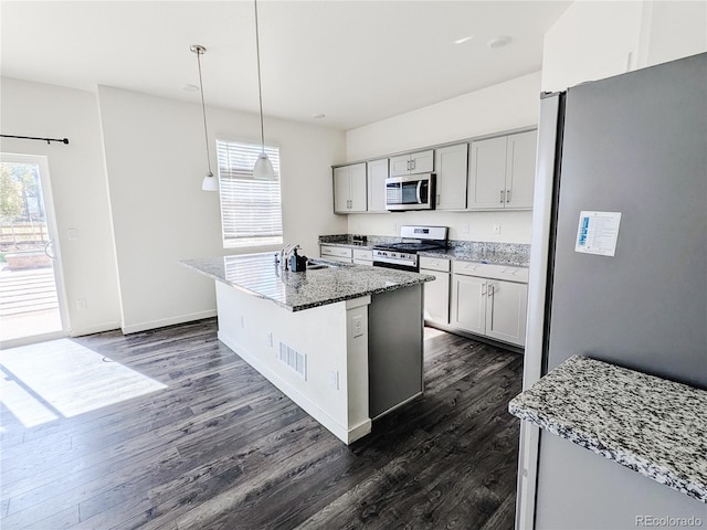 kitchen with decorative light fixtures, appliances with stainless steel finishes, dark hardwood / wood-style flooring, and gray cabinetry