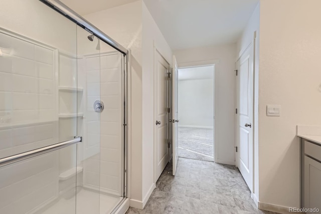 bathroom featuring vanity and a shower with door