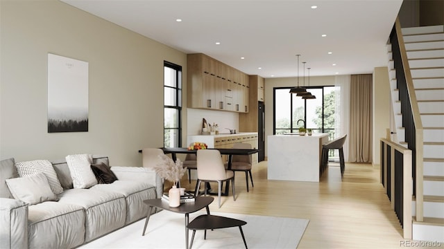 living room featuring sink and light hardwood / wood-style flooring