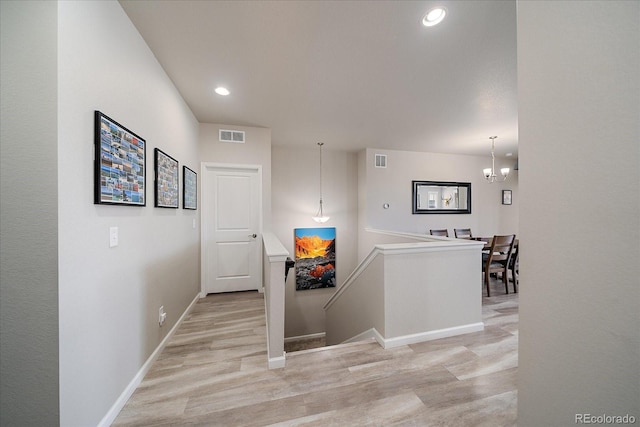 8908 Birch Run Ln, Parker, CO 80134 - hall featuring an upstairs landing, light wood-style flooring, recessed lighting, and a chandelier