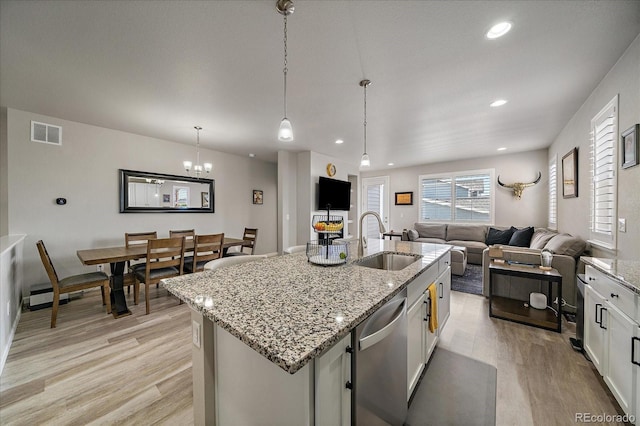 8908 Birch Run Ln, Parker, CO 80134 - kitchen with dishwasher, light wood finished floors, open floor plan, an island with sink, and recessed lighting