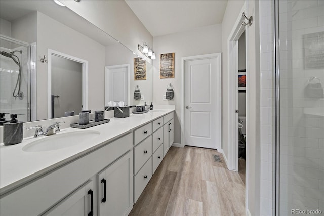8908 Birch Run Ln, Parker, CO 80134 - full bath with double vanity, a stall shower, and wood finished floors