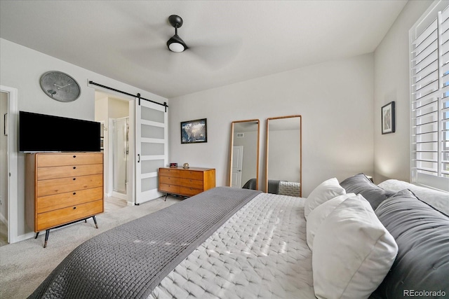 8908 Birch Run Ln, Parker, CO 80134 - bedroom with light colored carpet, a barn door, and a ceiling fan