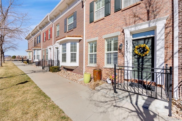 exterior space featuring a yard and brick siding