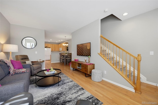 living room featuring light wood-style floors, recessed lighting, stairway, and baseboards