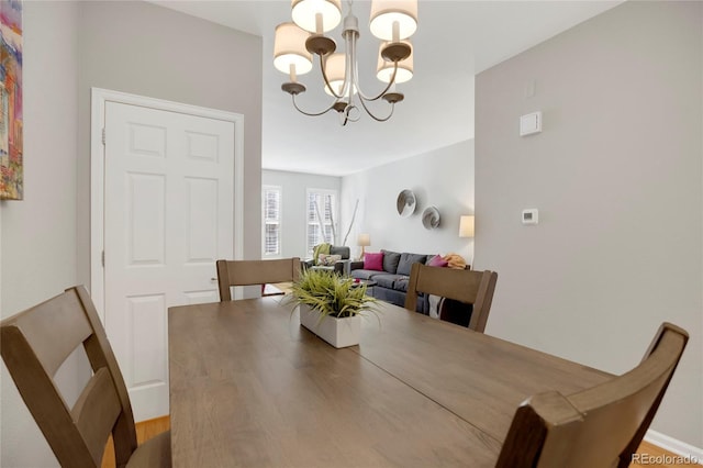 dining area featuring a notable chandelier and wood finished floors