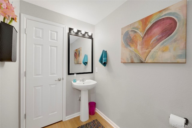 bathroom featuring baseboards and wood finished floors