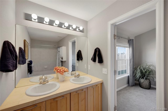 bathroom featuring a sink, shower / bathtub combination with curtain, and double vanity