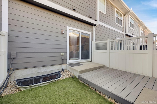 wooden terrace featuring a yard