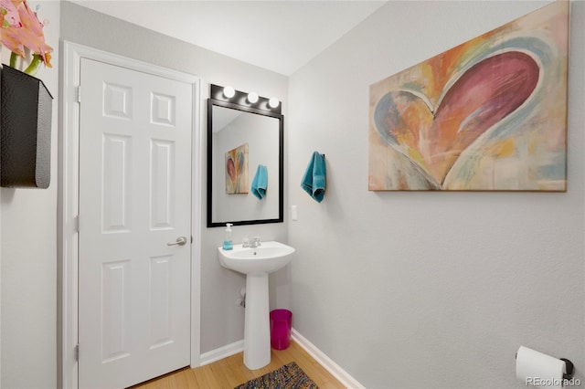 4357 W 118th Pl, Westminster, CO 80031 - bathroom featuring baseboards, a sink, and wood finished floors