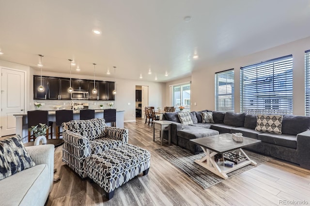 10991 Xanadu St, Commerce City, CO 80022 - living area featuring wood finished floors and recessed lighting