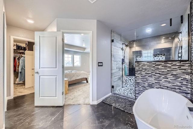 10991 Xanadu St, Commerce City, CO 80022 - full bathroom featuring ensuite bath, a stall shower, a freestanding bath, marble finish flooring, and a walk in closet