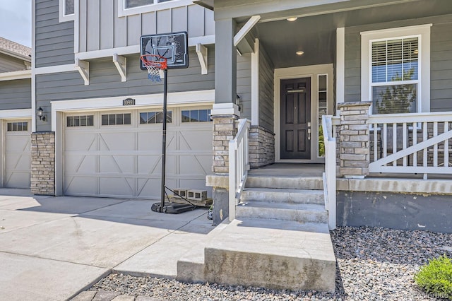 10991 Xanadu St, Commerce City, CO 80022 - view of exterior entry featuring stone siding, a garage, board and batten siding, and concrete driveway