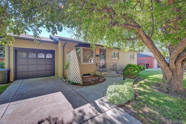 6054 Iris Way, Arvada, CO 80004 - single story home featuring concrete driveway, an attached garage, and brick siding
