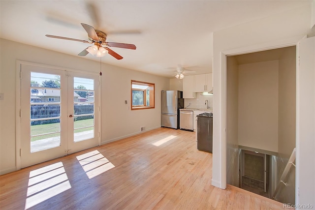 6054 Iris Way, Arvada, CO 80004 - kitchen with appliances with stainless steel finishes, white cabinetry, light wood-type flooring, a ceiling fan, and light countertops