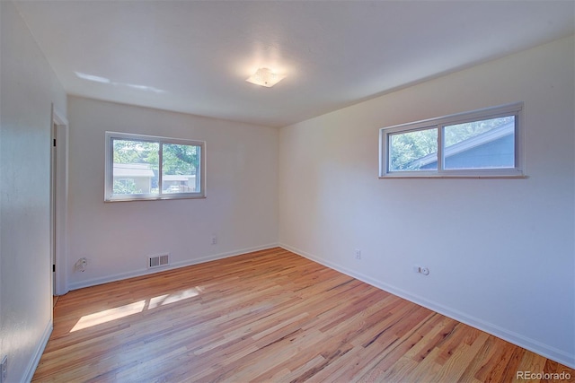 6054 Iris Way, Arvada, CO 80004 - unfurnished room featuring plenty of natural light and light wood-style floors