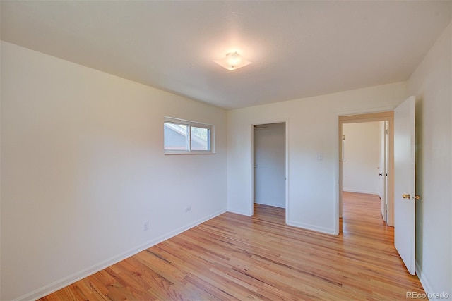 6054 Iris Way, Arvada, CO 80004 - unfurnished bedroom featuring light wood-style flooring and a closet