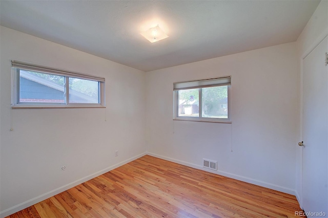 6054 Iris Way, Arvada, CO 80004 - empty room with healthy amount of natural light and light wood-type flooring