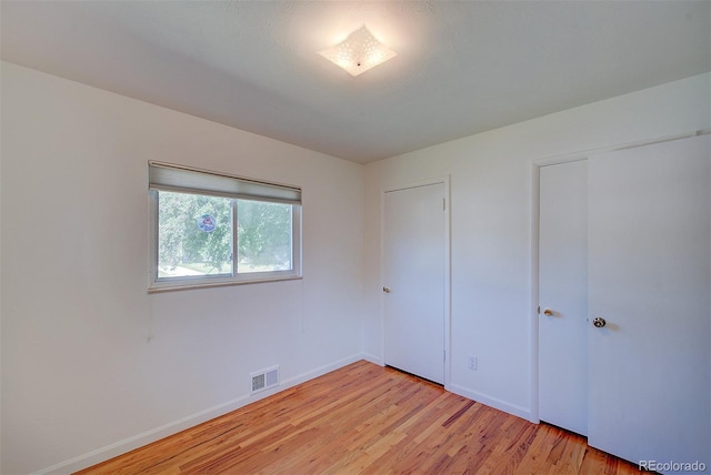 6054 Iris Way, Arvada, CO 80004 - unfurnished bedroom featuring light wood finished floors and baseboards