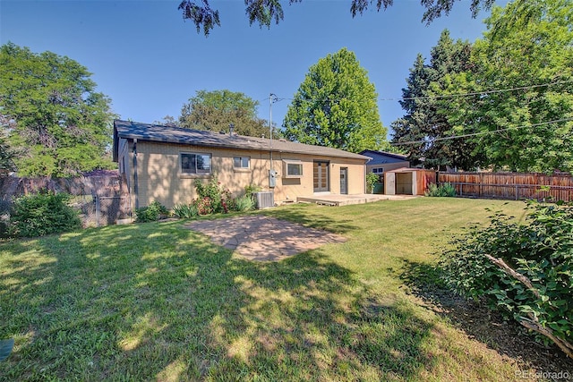 6054 Iris Way, Arvada, CO 80004 - back of house featuring a shed, a patio area, and a fenced backyard