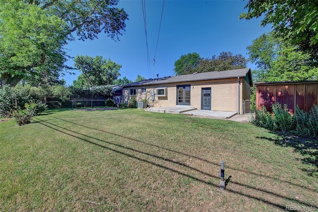 6054 Iris Way, Arvada, CO 80004 - rear view of property with a patio and brick siding