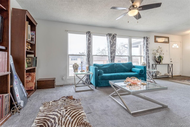 carpeted living room with a textured ceiling and ceiling fan