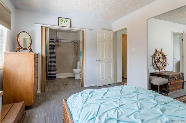 bedroom featuring hardwood / wood-style flooring, a textured ceiling, and ensuite bathroom