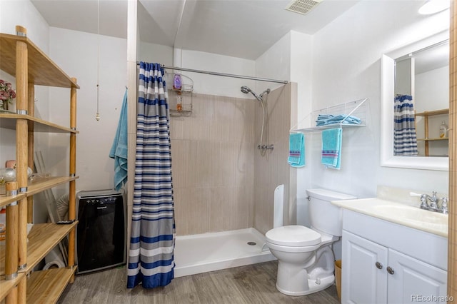 bathroom with walk in shower, vanity, toilet, and hardwood / wood-style floors