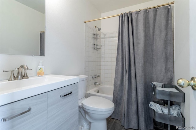 full bathroom with vanity, shower / tub combo with curtain, and toilet