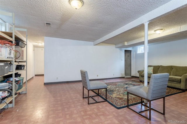 living room featuring parquet flooring and a textured ceiling