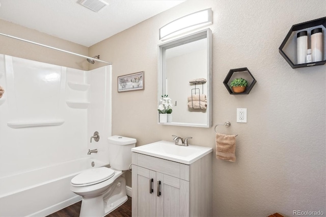 full bathroom with vanity, toilet, tub / shower combination, wood finished floors, and visible vents