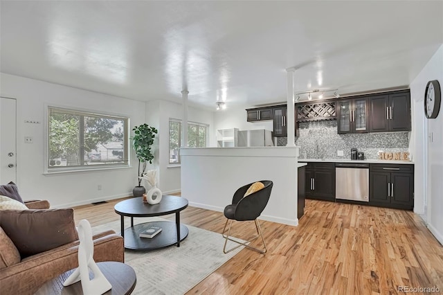 3052 S Grape Way, Denver, CO 80222 - living room with bar with sink and light wood-style floors