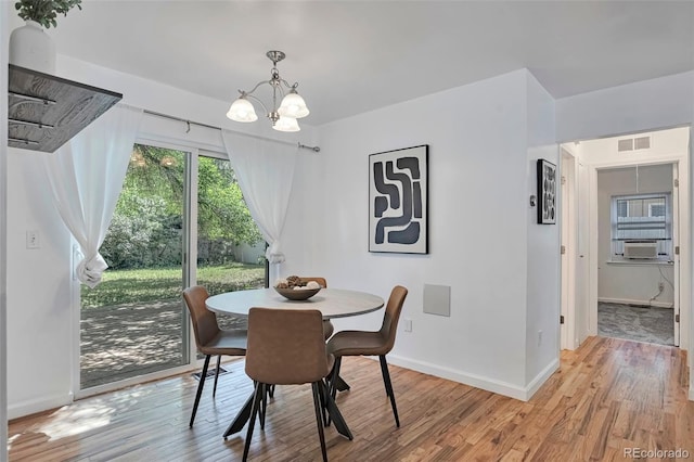 3052 S Grape Way, Denver, CO 80222 - dining room featuring light wood finished floors, a chandelier, and cooling unit