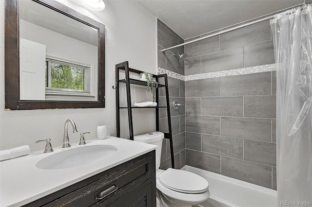 3052 S Grape Way, Denver, CO 80222 - full bathroom with vanity, a tile shower, a textured ceiling, and a textured wall