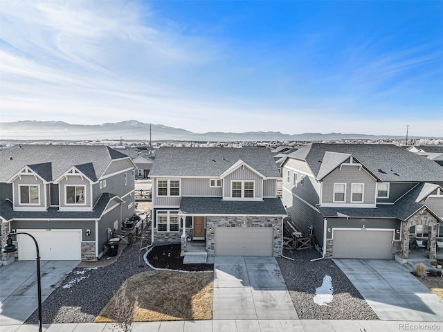 view of front of home featuring a residential view, a mountain view, and board and batten siding