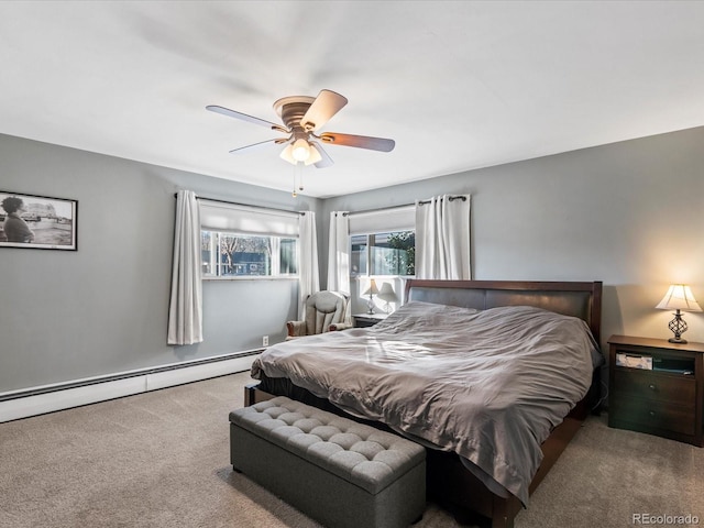 carpeted bedroom featuring a baseboard heating unit and ceiling fan