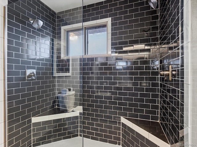 bathroom with tiled shower