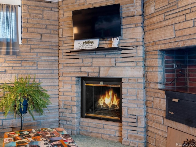 interior details with carpet and a stone fireplace