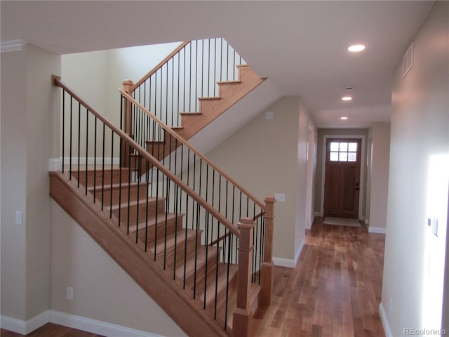 foyer with recessed lighting, visible vents, baseboards, and wood finished floors