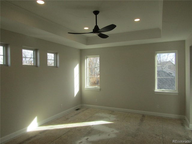 spare room with baseboards, a raised ceiling, a ceiling fan, and recessed lighting