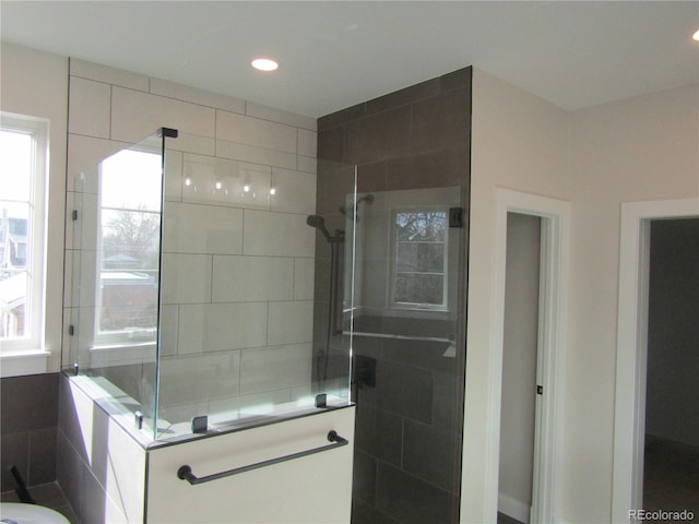 full bath with a walk in shower and recessed lighting