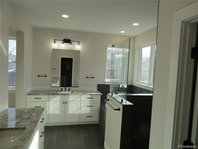 bathroom with tile patterned floors, two vanities, a sink, and recessed lighting