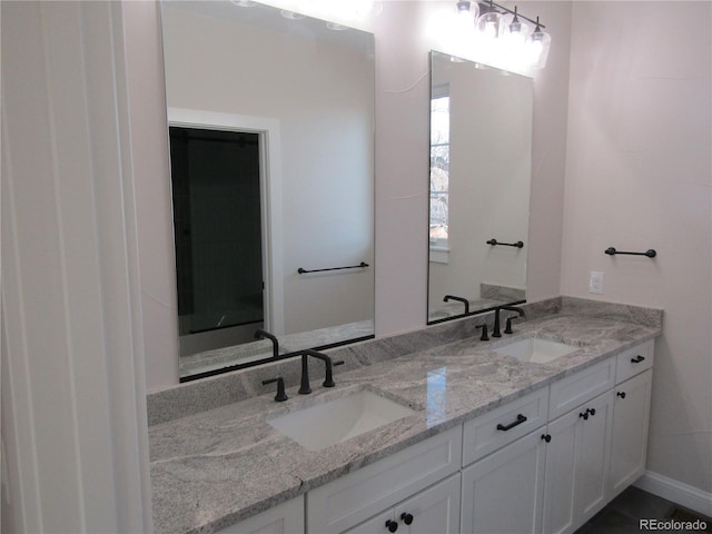 bathroom featuring a sink and double vanity