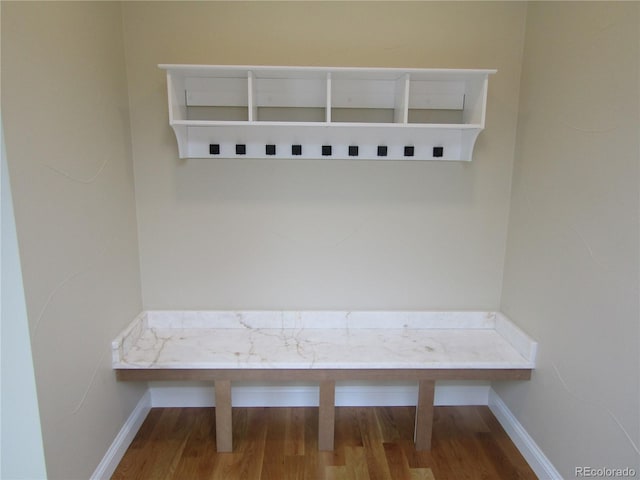 mudroom featuring baseboards and wood finished floors