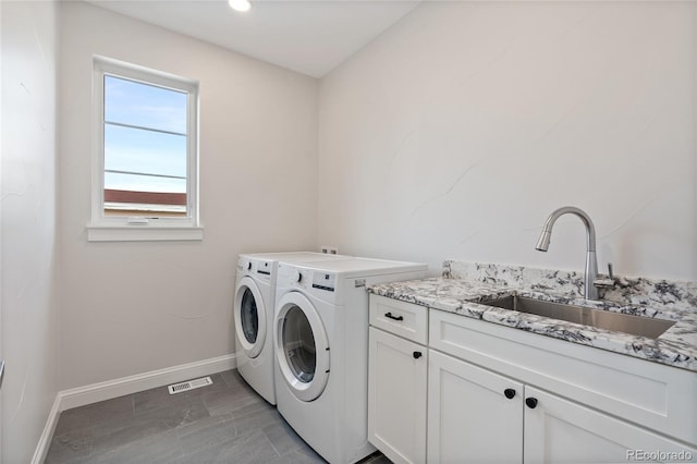 1970 S Logan St, Denver, CO 80210 - laundry room featuring separate washer and dryer, baseboards, and cabinet space