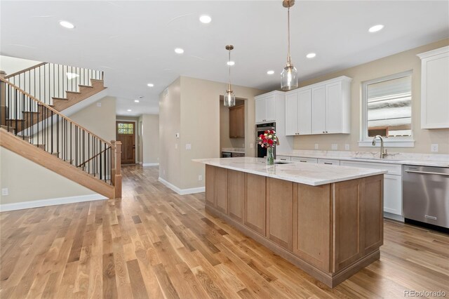 1970 S Logan St, Denver, CO 80210 - kitchen featuring appliances with stainless steel finishes, a sink, light wood finished floors, white cabinetry, and recessed lighting