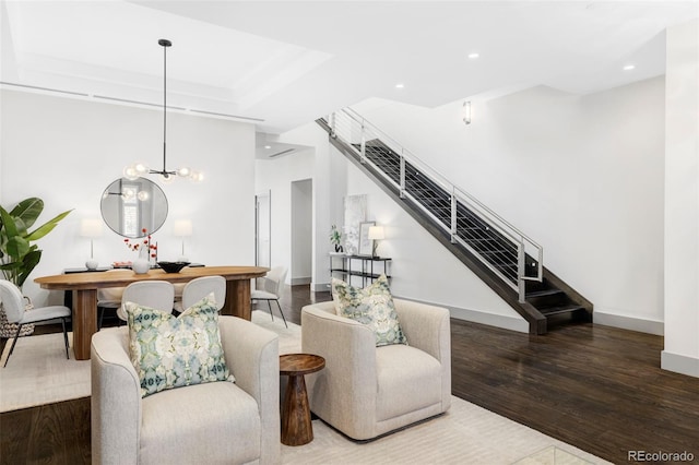 living room with a notable chandelier and hardwood / wood-style floors