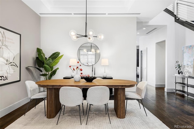 dining space with a chandelier and hardwood / wood-style floors