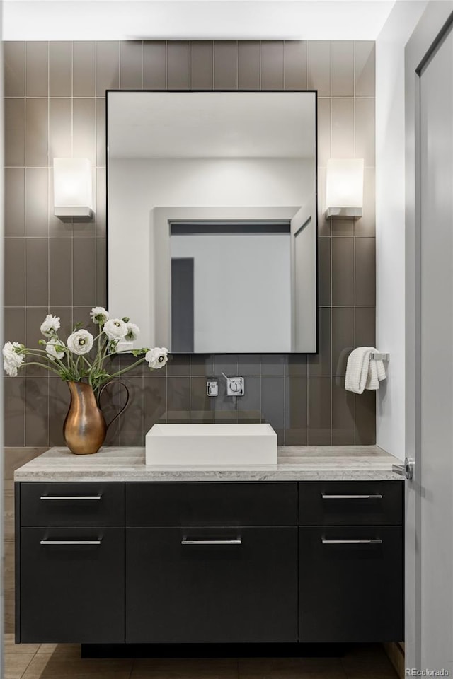 bathroom with tile walls and vanity