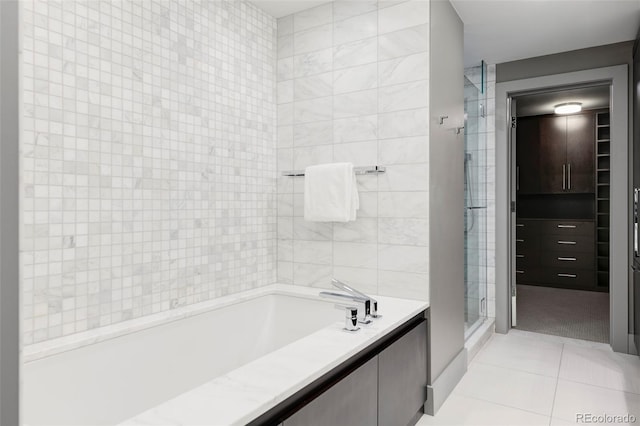 bathroom with plus walk in shower, tile walls, and tile patterned floors